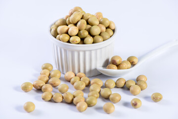 Yellow-green Taiwanese organic non-GMO soybeans, soy beans in a container isolated on white backgorund, close up, clipping path.