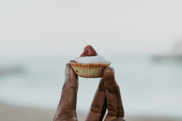 Holding a strawberry baked snack