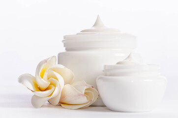 Beautiful flowers and  jars of natural body cream