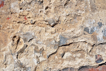 Empty old brick wall texture. Shabby facade of a building with damaged plaster.