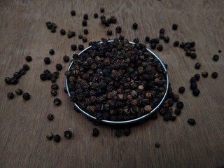 black pepper in a wooden bowl