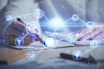 Social network theme hologram over hands taking notes background. Concept of global international people connect. Double exposure