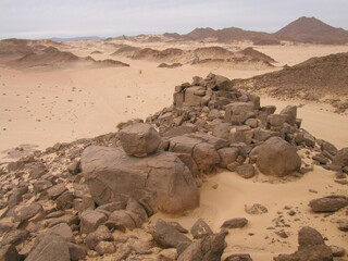 Fototapeta na wymiar TAMANRASSET, HOGGAR MOUNTAINS. THE SAHARA DESERT IN SOUTHERN ALGERIA. SAND DUNES AND ROCK FORMATIONS.