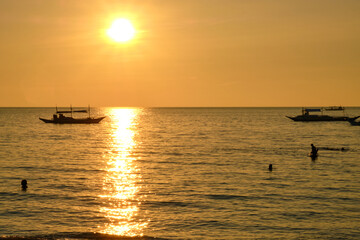 Boracay, Philippines - Jan 27, 2020: Sunset on Boracay island. Sailing and other traditional boats...