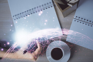 Social network theme hologram over hands taking notes background. Concept of global international...
