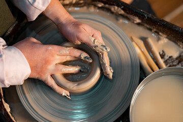 Close up of Woman Hands Working on Pottery Wheel With Clay