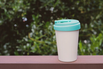 Reusable eco-friendly bamboo cup with lid, copy space.