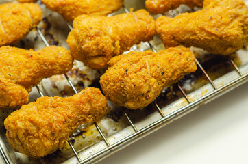 Southern crispy battered fried chicken wings, deep-fried chicken wings on the metal tray