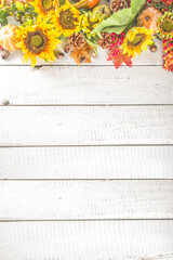 Festive autumn background, still life decor with pumpkins, berries, leaves on white wooden background. Concept background for Thanksgiving or Halloween holiday, copy space, flatlay