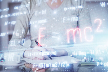 Science formula hologram over woman's hands taking notes background. Concept of study. Multi exposure