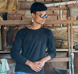 Portrait of a teenager young boy wearing black shirt with sunglasses and looking another side