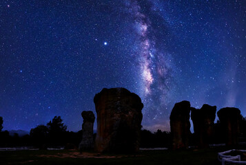 The Milky Way galaxy in the sky on the Stonehenge Thailand .Long exposure photograph, with grain.Image contain certain grain or noise and soft focus. © sunti