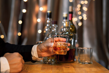 Closeup businessmen holding a glass of whiskey