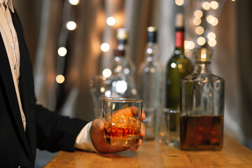 Closeup businessmen holding a glass of whiskey