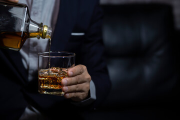 Closeup businessmen holding a glass of whiskey