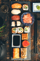 Flat-lay of sushi set on old wooden background, flat lay