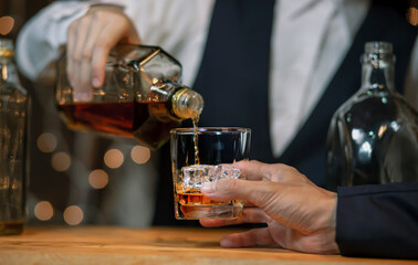 Bartender Serve Whiskey on wood bar