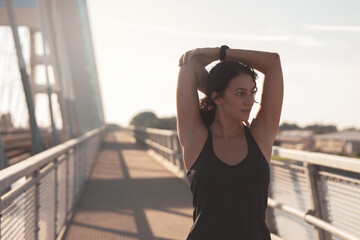 Young woman doing a Arm stretching exercise	
