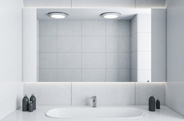 Modern interior of bathroom with washbasin faucet and mirror.