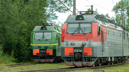 Obraz premium two electric trains standing on the railway tracks in the depot