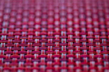 Fototapeta premium Vivid red basket weave mesh texture background with limited focus