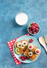 Funny breakfast toast for kids shaped as cute owl, dog. Food art sandwich for child. Isolated. Animal faces toasts with spreads, fruits