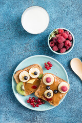 Funny breakfast toast for kids shaped as cute owl, dog. Food art sandwich for child. Isolated. Animal faces toasts with spreads, fruits