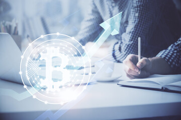 Blockchain theme hologram with man working on computer on background. Concept of crypto chain. Double exposure.