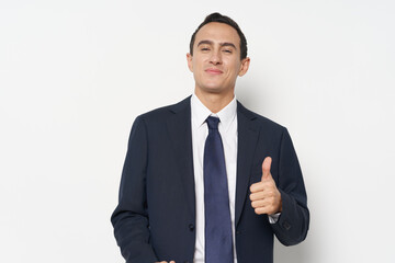Business man shows a positive hand gesture and smiles