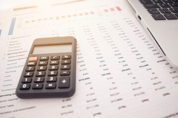 calculator with financial statements on a white background
