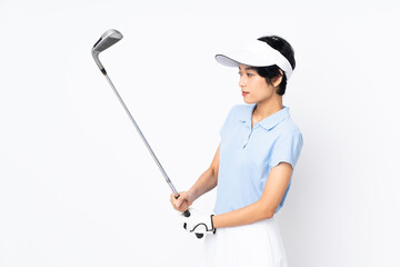 Young Vietnamese golfer woman over isolated white wall playing golf