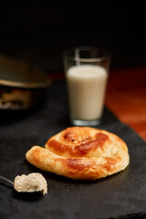Freshly made pastry burek on black stone cutting board. Very shallow depth of field
