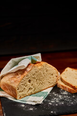 Freshly made white bread on black stone cutting board. Very shallow depth of field