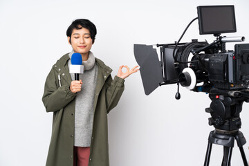 Reporter Vietnamese woman holding a microphone and reporting news in zen pose