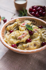 Preparing dumplings with cherry. making pierogi or pyrohy, varenyky. Traditional Russian cuisine, or  Ukrainian hand-made vareniki