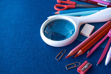 Stationery set on blue background. School supplies top view for advertising and promotional items. Back to school concept