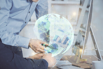 Social network theme hologram with businessman working on computer on background. Multi exposure.