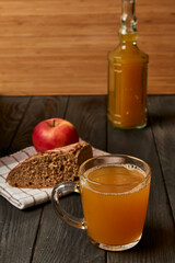 Kvass drink in a glass jar on an old wooden board with rye bread 
