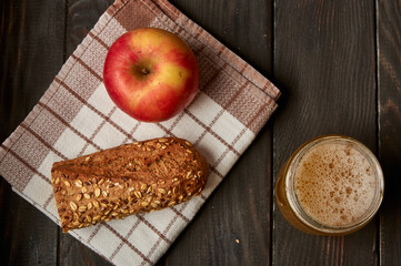 Kvass drink in a glass jar on an old wooden board with rye bread 