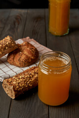 Kvass drink in a glass jar on an old wooden board with rye bread 