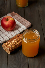 Kvass drink in a glass jar on an old wooden board with rye bread 