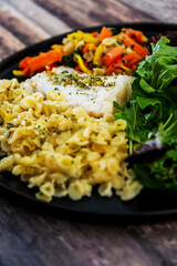 cod fish with vegetables, small vegetables and marine sauce