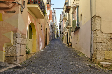 Fototapeta na wymiar A narrow street between the old buildings of Venafro, a medieval village in the Molise region.