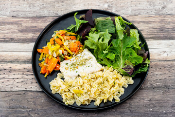 cod fish with vegetables, small vegetables and marine sauce