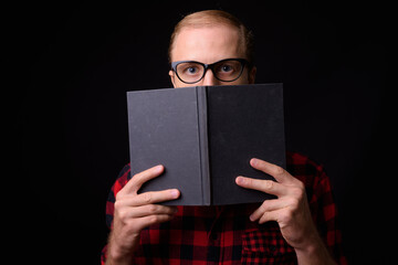 Man with blond hair against black background