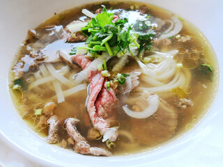 Bowls of Asian soup noodles and beef