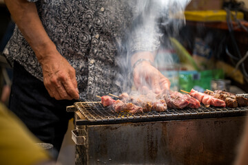 close-up of a man making barbecue