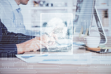 Fingerprint hologram with businessman working on computer on background. Security concept. Double exposure.