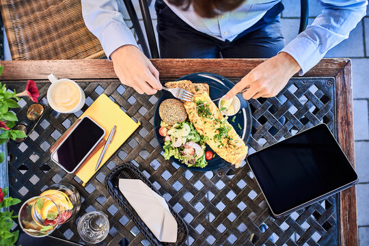 Overhead View Of Young Businessman Eating Breakfast