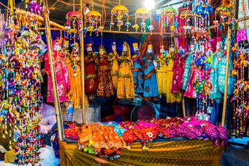 Fototapeta premium Colorful handmade Rajasthani puppet KATHPUTLI and colorful dresses in a doll shop in New Delhi, India